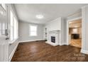 Bright living room featuring a decorative fireplace, built-in shelves, and newer hard wood floors at 903 Rhode Island Ave, Kannapolis, NC 28083