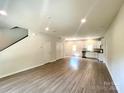 Spacious living room featuring hardwood floors, neutral walls, and ample natural light at 907 W Georgia Ave, Bessemer City, NC 28016