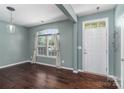 Bright entryway with hardwood floors, a large window, and a white front door at 1027 Writers Way, Cornelius, NC 28031