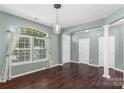 Spacious living room featuring hardwood floors, ample natural light, and architectural columns at 1027 Writers Way, Cornelius, NC 28031