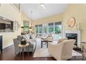 Bright living room with fireplace, large windows, and hardwood floors at 13733 Castleford Dr, Mint Hill, NC 28227