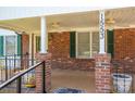 Inviting front porch with ceiling fans, brick columns, and ample space for outdoor seating at 1553 Home Trl # 51, Lincolnton, NC 28092