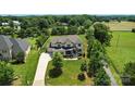 A sprawling home is set on a manicured lot with mature trees at 200 Squash Harvest Ct, Matthews, NC 28104