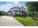 A well-manicured lawn surrounds this home with a side entry three car garage at 200 Squash Harvest Ct, Matthews, NC 28104