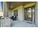 Inviting covered porch with brick pillars and stylish seating welcomes visitors at 200 Squash Harvest Ct, Matthews, NC 28104