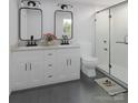 Modern bathroom with double vanity, sleek fixtures, and glass enclosed shower at 2063 Sadler Woods Ln, Charlotte, NC 28214