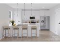 Modern kitchen with white cabinets, stainless steel appliances, and a quartz countertop island at 2063 Sadler Woods Ln, Charlotte, NC 28214