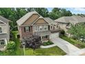 Aerial view of a beautiful two-story home, showcasing its lush landscaping and attached two-car garage at 2377 Maple Grove Nw Ln, Concord, NC 28027