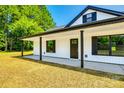 Inviting exterior with black door and trim, showcasing the home's entrance and covered porch at 3248 Ferguson Long Rd, York, SC 29745