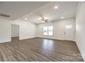 Bright, open-concept living area with neutral walls and modern laminate flooring, exuding a welcoming ambiance at 3248 Ferguson Long Rd, York, SC 29745