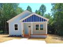 Lovely single-story home with a light blue exterior and inviting front porch at 372 Lippard Farm Rd, Statesville, NC 28625