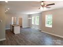 Bright, open-concept living space with an island bar and modern light fixtures at 372 Lippard Farm Rd, Statesville, NC 28625
