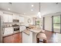 Bright kitchen with granite countertops, stainless steel appliances, and a breakfast bar with seating at 3816 Ernie Dr, Charlotte, NC 28269