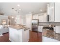 Spacious kitchen with white cabinets, granite countertops, stainless steel appliances, and hardwood floors at 3816 Ernie Dr, Charlotte, NC 28269