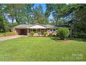 Brick home with lush green lawn and manicured landscaping, enhancing its classic appeal and curb presence at 4322 Greenhaven Ln, Gastonia, NC 28056