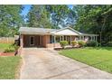 Ranch-style brick home with a carport, well-maintained lawn, and simple landscaping, offering comfortable living at 4322 Greenhaven Ln, Gastonia, NC 28056