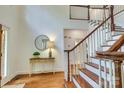 Inviting foyer with hardwood floors, a staircase, and a decorative table at 5051 Carillon Way, Charlotte, NC 28270