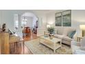 Cozy living room with neutral decor and an archway leading to the dining area at 5051 Carillon Way, Charlotte, NC 28270
