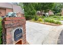 Inviting front yard featuring a well-kept lawn, a stately brick mailbox, and a long driveway at 5205 Tedorill Ln, Charlotte, NC 28226