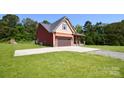 Charming two-story home with a long driveway and a two-car garage at 670 Cricket Ln, Mt Ulla, NC 28125