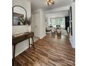Stylish foyer featuring wood floors, a console table, and a view of the open-concept living area with natural light at 7228 Rollingridge Dr, Charlotte, NC 28211