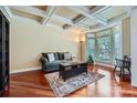 Comfortable living room with coffered ceilings, hardwood floors, large bay windows, and stylish decor at 844 Clonmel Dr, Matthews, NC 28104