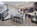Open concept kitchen with dark cabinets, stainless steel appliances and adjacent dining area at 113 Missouri Ln, Mount Holly, NC 28120