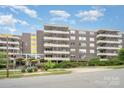 Apartment building featuring an open-air entry with multiple balconies for each unit at 1300 Reece Rd # 402, Charlotte, NC 28209
