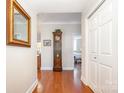 Entry hallway with coat closet, wood floors, and decorative touches at 1300 Reece Rd # 402, Charlotte, NC 28209