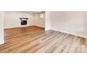Spacious living room features new floors and a charming brick fireplace at 1606 N Rhyne St, Gastonia, NC 28054