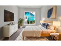 Serene main bedroom with neutral tones, stylish decor, and ample natural light from the large window at 16815 Spruell St, Huntersville, NC 28078