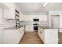 Modern kitchen with white cabinets, stainless steel appliances, a kitchen island, and granite countertops at 172 Briana Marie Way, Indian Trail, NC 28079