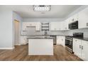 Bright kitchen features white cabinets, granite countertops, a kitchen island, and stainless steel appliances at 172 Briana Marie Way, Indian Trail, NC 28079