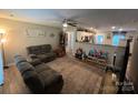 Open concept living room with plush reclining sofa and seamless flow into the kitchen at 1723 Lowder St, Albemarle, NC 28001