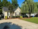 Inviting single-story home with manicured lawn, mature trees, and a spacious driveway at 2289 Kestrel Dr, Rock Hill, SC 29732