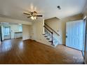 Inviting living room featuring hardwood floors, a ceiling fan, and access to the staircase and kitchen at 250 Nixon Rd # 41, Belmont, NC 28012