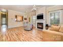 Bright living room with fireplace, hardwood floors, and a cozy seating area at 2773 Clover Nw Rd, Concord, NC 28027