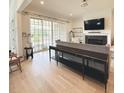 Bright living room featuring hardwood flooring, fireplace, and sliding glass doors to the deck at 3011 Ella Katherine Way, Charlotte, NC 28210