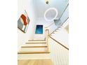 Bright staircase featuring wood treads, white risers, and modern lighting fixture at 3011 Ella Katherine Way, Charlotte, NC 28210