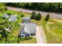 Aerial view of a home featuring a long driveway and proximity to railroad tracks and lush greenery at 400 N Main Gq St, Granite Quarry, NC 28146