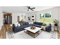 Bright, modern living room featuring a large sectional sofa and windows overlooking a green backyard at 400 N Main Gq St, Granite Quarry, NC 28146