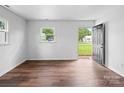 Bright and airy living room featuring hardwood floors and ample natural light from large windows at 405 Jones Street St, Monroe, NC 28110