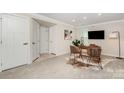 Cozy finished basement with carpet, featuring a desk and storage, perfect for an office space at 4436 Carteret St, Charlotte, NC 28205