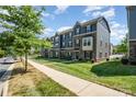 Street view of townhomes featuring stone accents, neat landscaping and inviting sidewalks at 4436 Carteret St, Charlotte, NC 28205