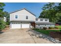 Charming home featuring a two-car garage and well-maintained front lawn, offering both convenience and curb appeal at 47209 Paradise Ln, Norwood, NC 28128