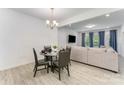 Dining area with modern table set near the living room with luxury vinyl plank flooring at 5010 Arbordale Way, Mount Holly, NC 28120