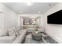Comfortable living area with a sectional sofa and an open floor plan at 5010 Arbordale Way, Mount Holly, NC 28120