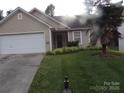 Attractive single-story home featuring a well-kept lawn and cozy entrance at 569 River View Dr, Lowell, NC 28098