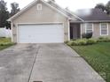 Neat single-story home with a two-car garage and pleasant curb appeal at 569 River View Dr, Lowell, NC 28098
