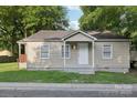 Quaint single-story house with a covered entry and well-maintained lawn at 603 Paradise St, Monroe, NC 28112